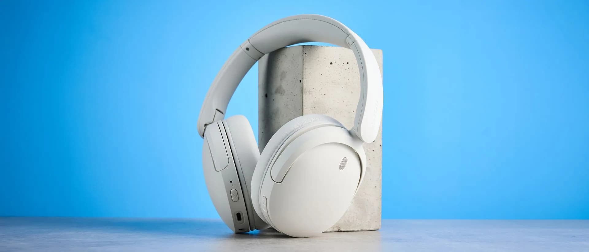 Sony WH-CH730N headphones in beige, folded flat on a white surface