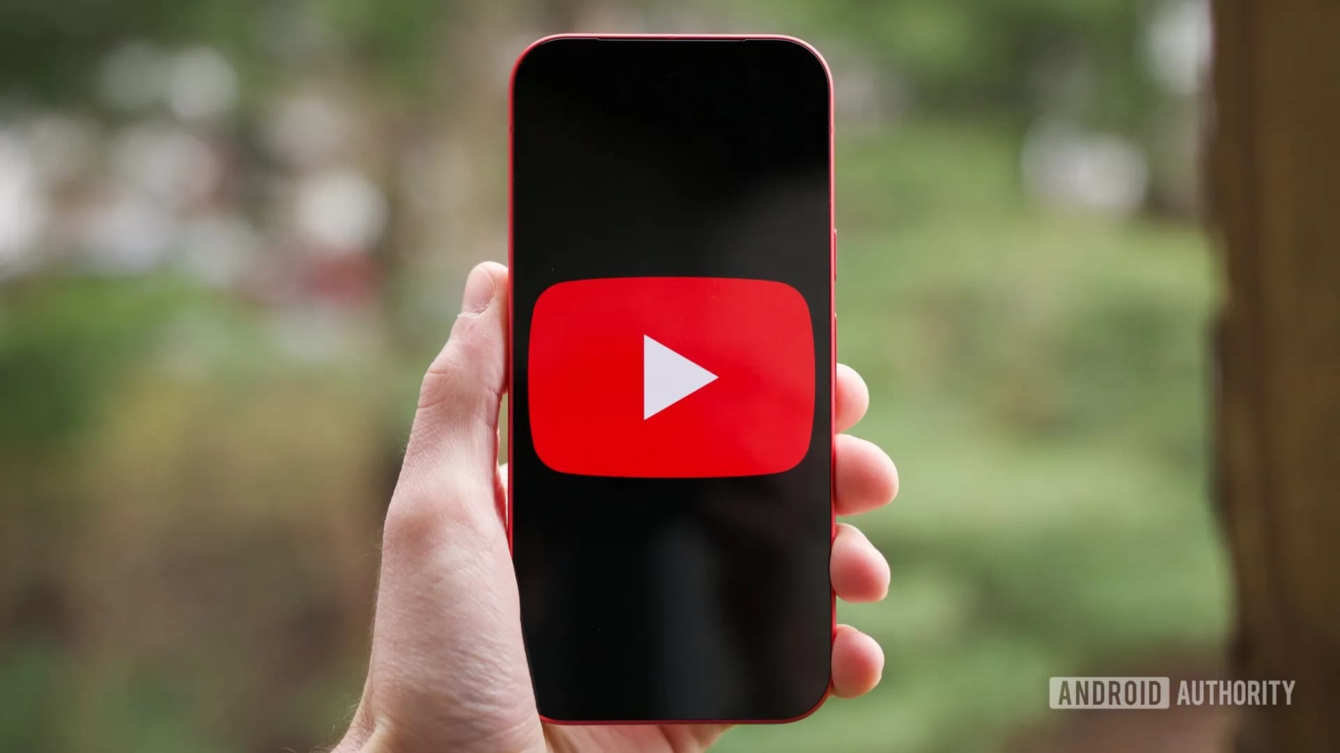 The YouTube logo displayed on a smartphone screen against a red background