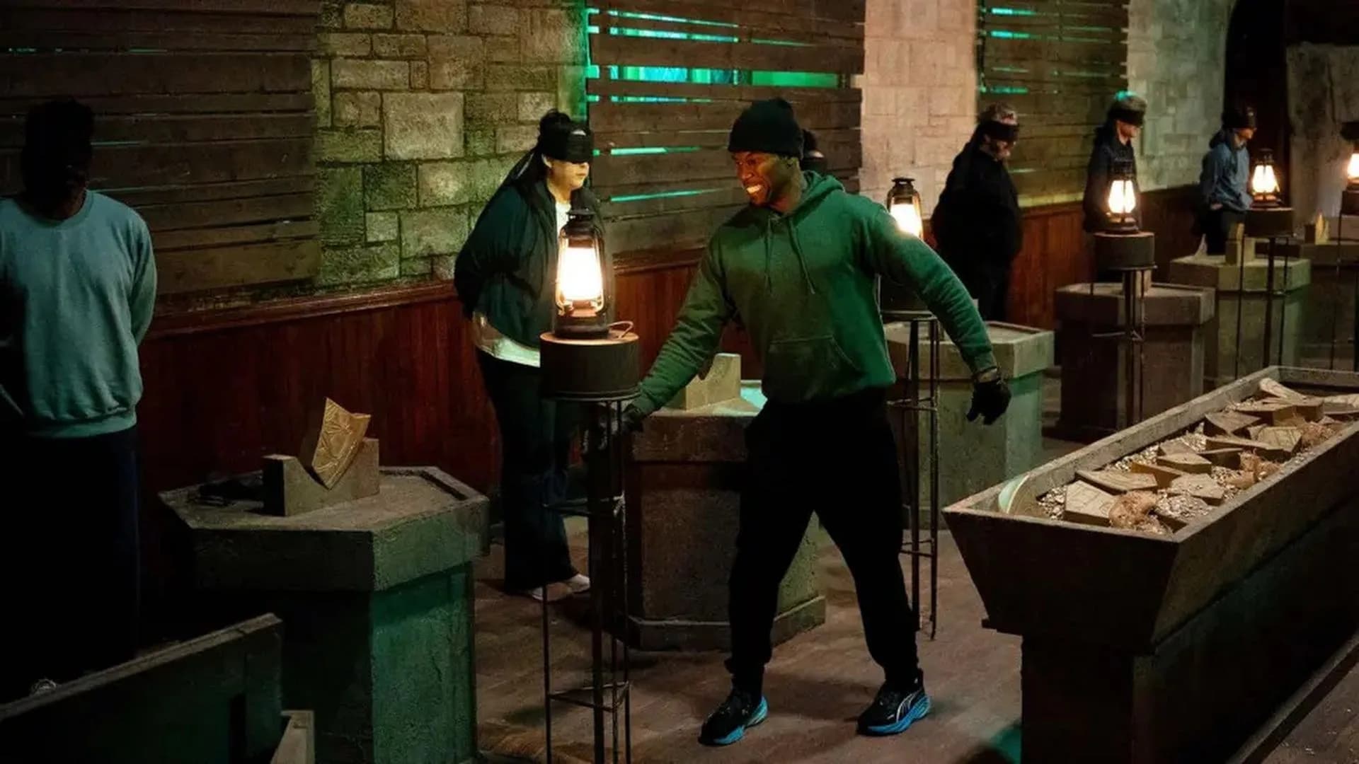 Promotional image for The Celebrity Traitors U.K. season 2 showing the cast around the Round Table