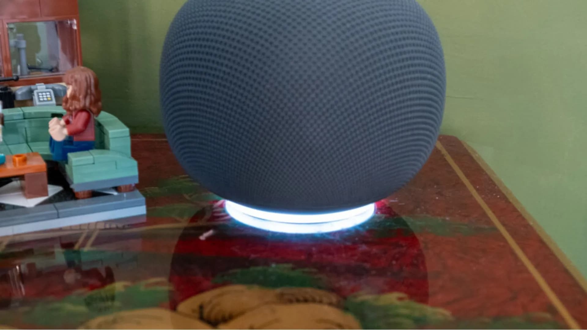 Google Nest smart speaker and Nest camera on a shelf representing the Google Home ecosystem