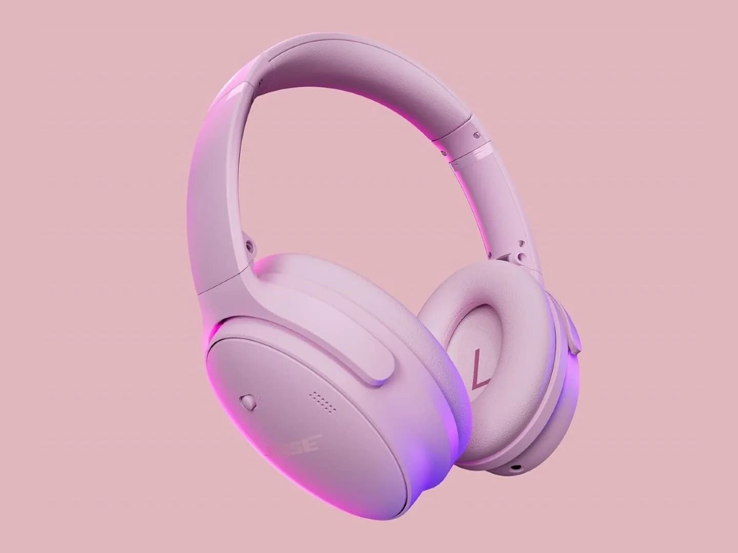 First-generation Bose QuietComfort over-ear headphones sitting on a neutral desk surface.