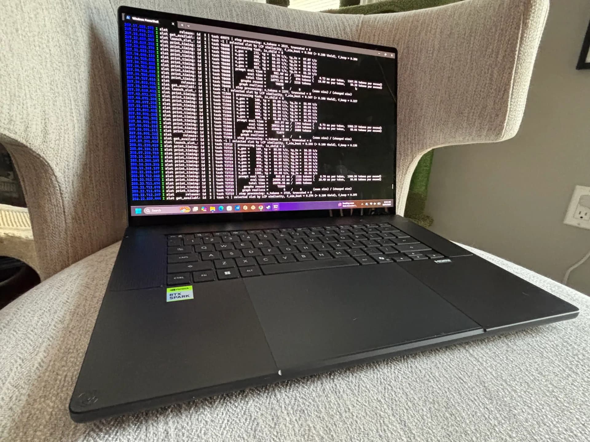 The all-metal black Asus ProArt P16 laptop open on a desk, showing its 16-inch OLED display.