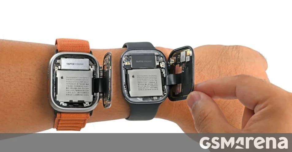 Disassembled smartwatch screen and internal components resting on an electronic repair workspace