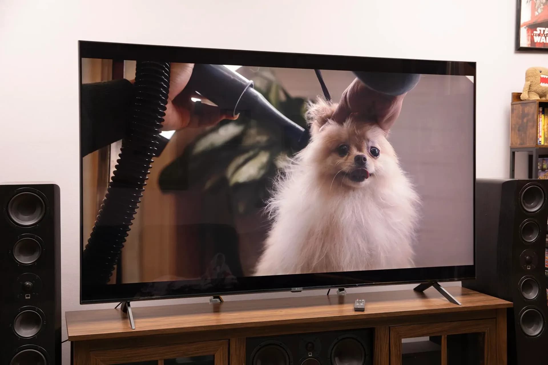 The front view of the LG MRGB95B Micro RGB television standing on a media console.