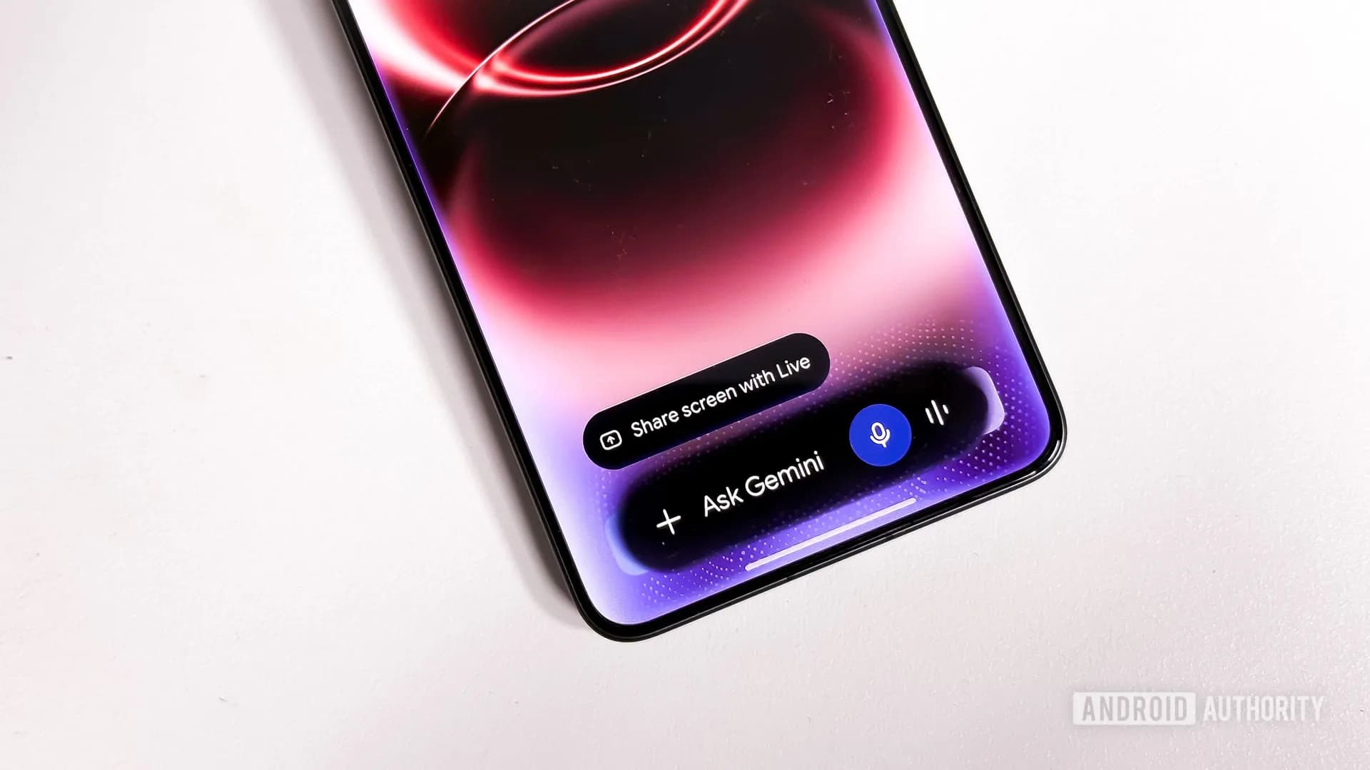The Gemini overlay on an Android phone showing a sparkling animation and shaded edges around the Ask Gemini text box
