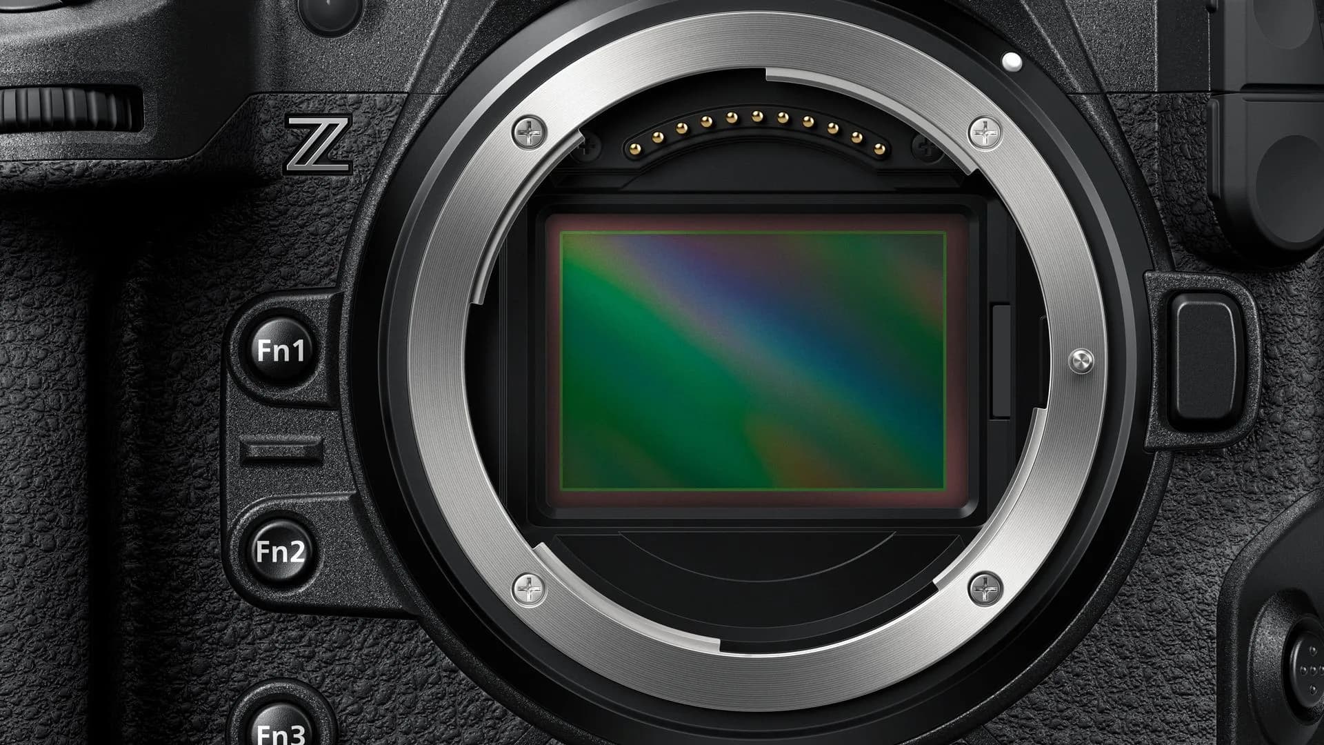 A Nikon mirrorless camera mounted with a prime lens on a studio tabletop