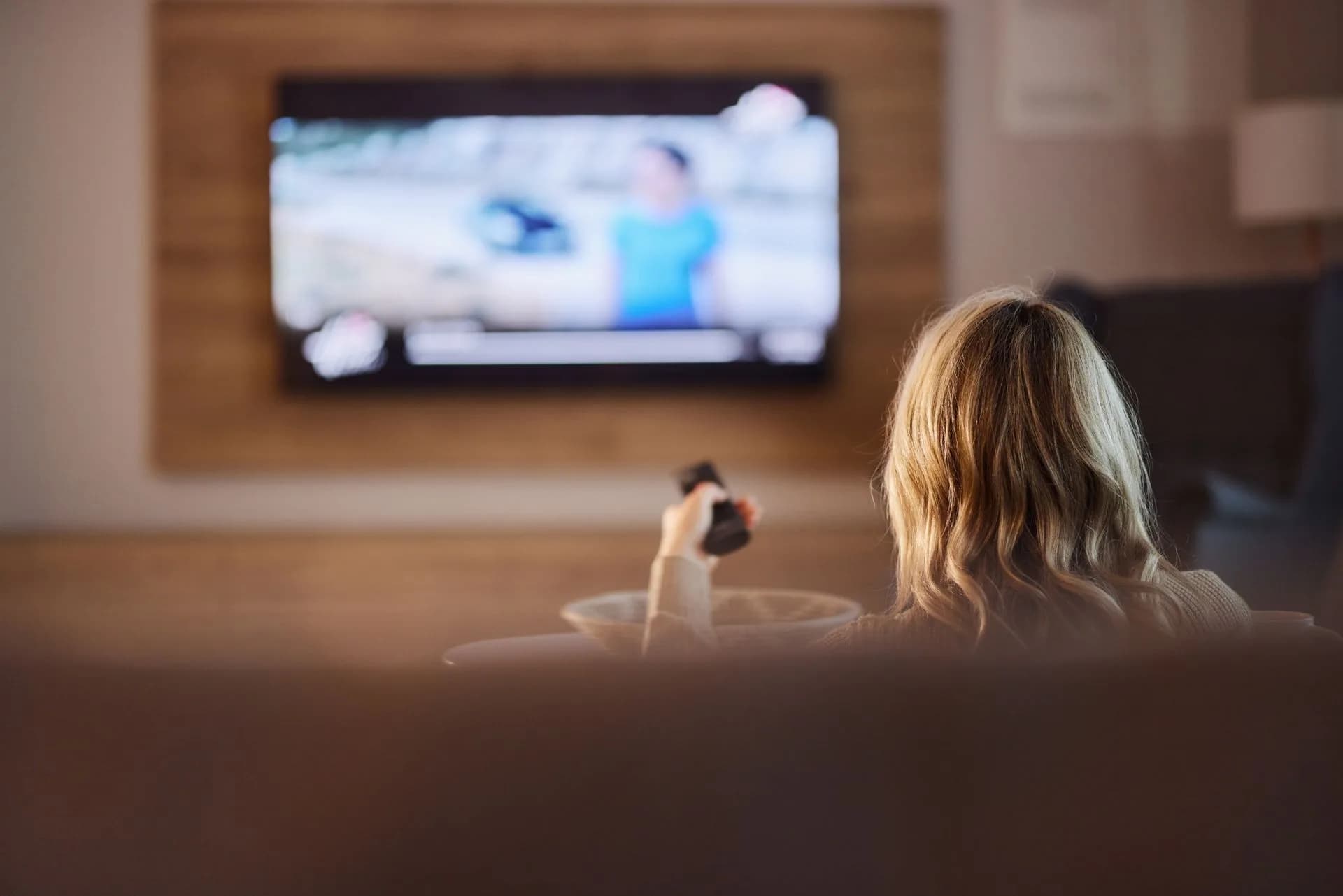 A Samsung smart TV displaying the Tizen home screen interface in a living room