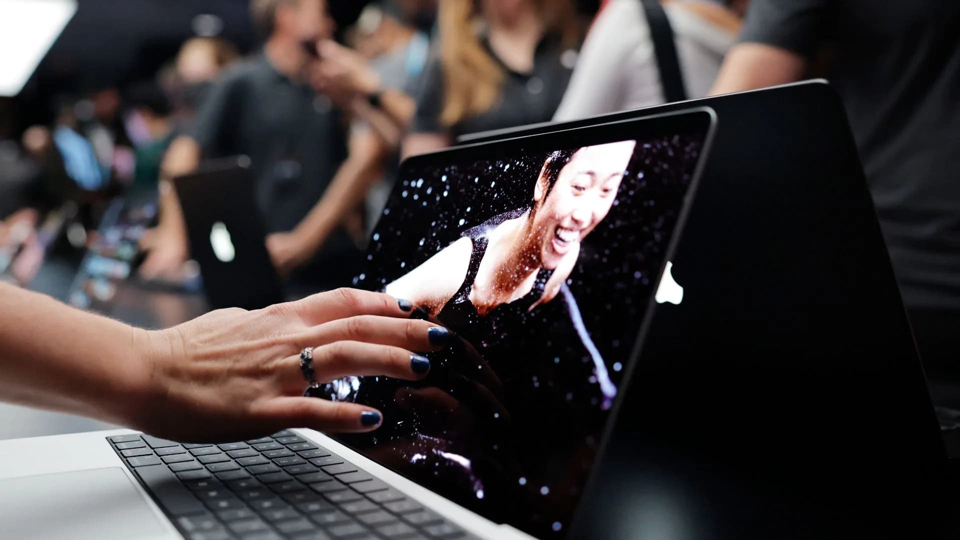 Apple MacBook Pro laptop with a PROLED XDR touchscreen display open on a desk