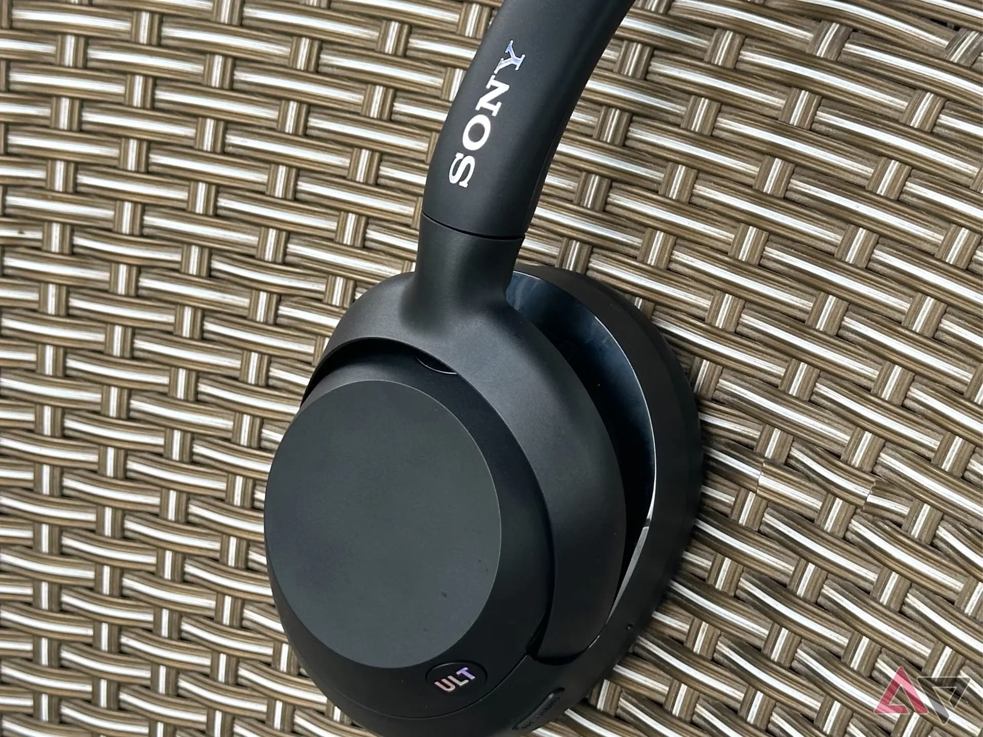 Sony Ult Wear over-ear wireless headphones resting on a wooden table.