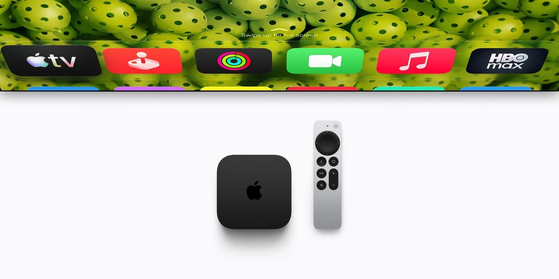 Apple TV 4K streaming box shown alongside its remote on a table.