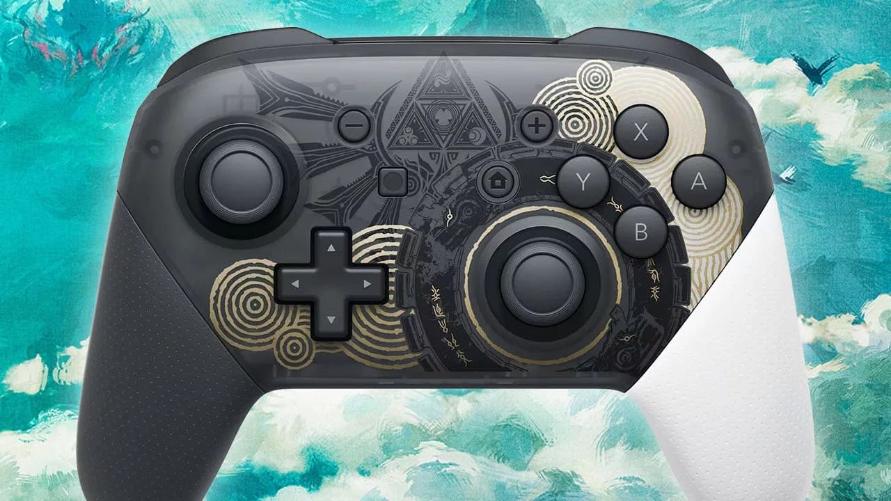 The Legend of Zelda: Tears of the Kingdom Edition Nintendo Switch Pro controller on a dark background, showing gold Triforce detailing and navy grip texture.