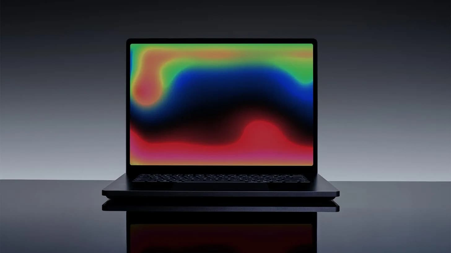 A high-end laptop sitting on a clean minimalist desk surface
