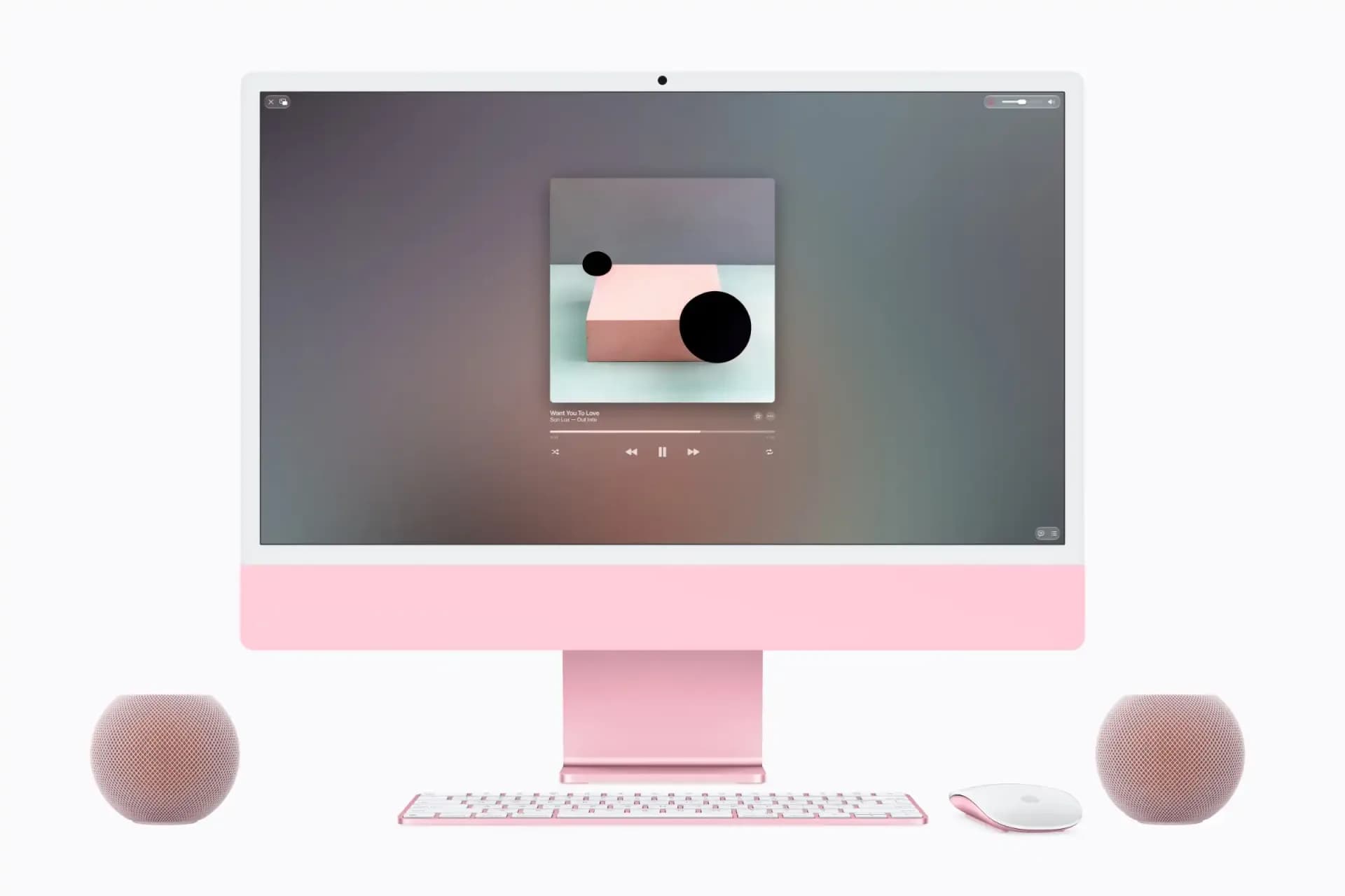 Apple HomePod mini 2 placed beside a Mac on a clean workspace desk