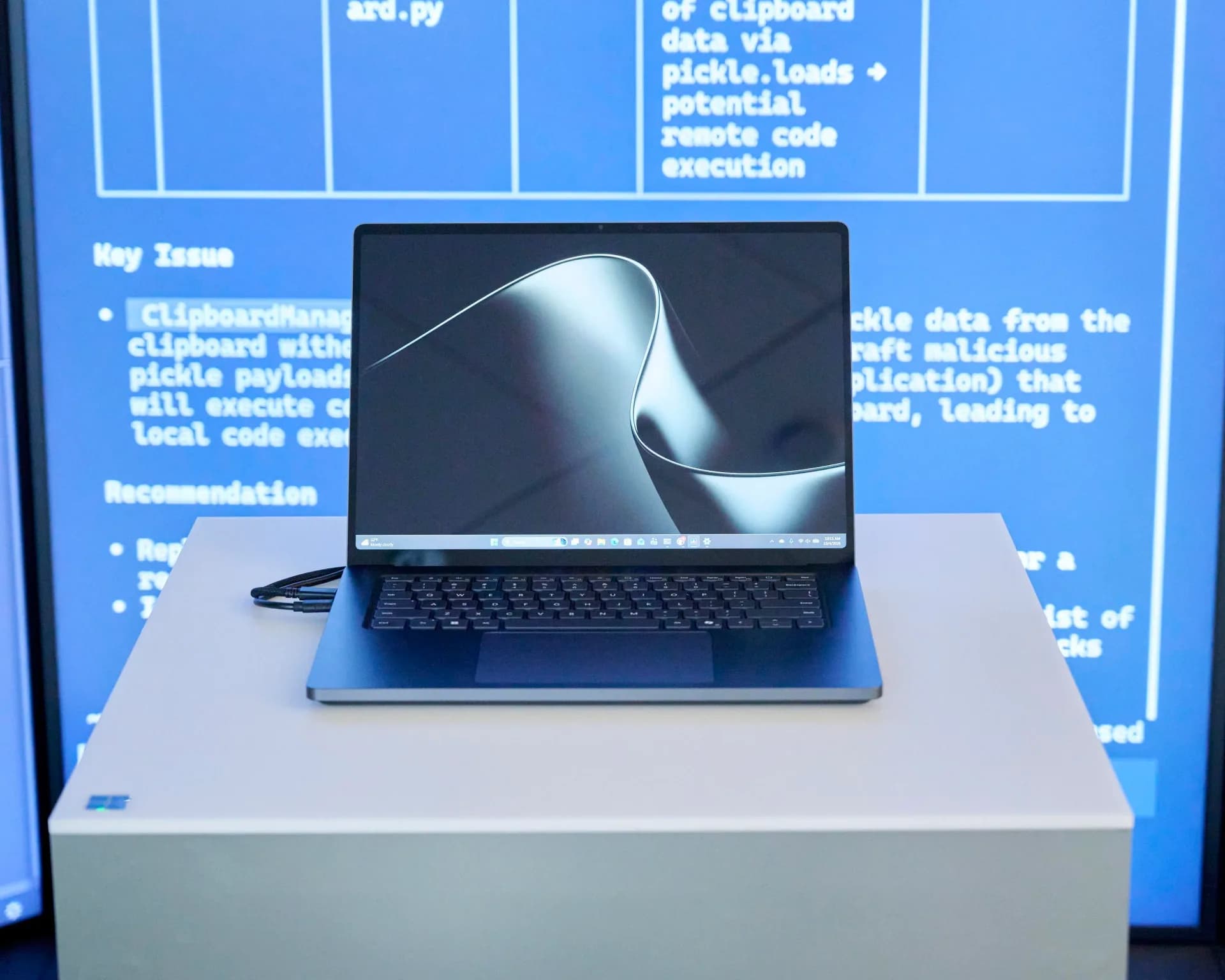 Microsoft Surface Laptop Ultra in Nightfall color, closed, next to a USB-C magnetic charger