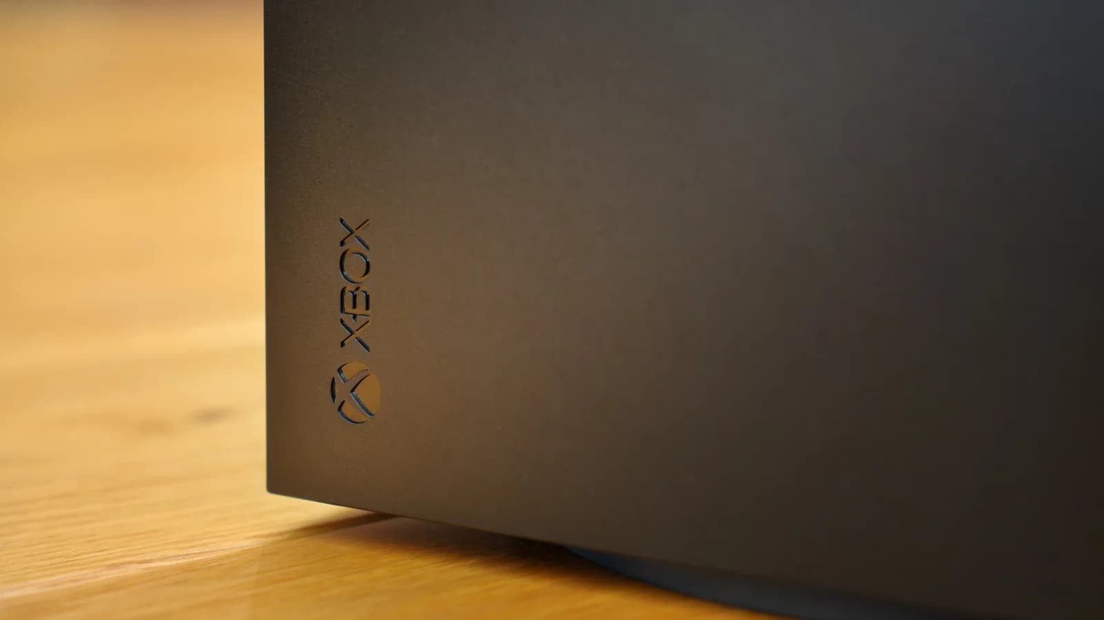 Xbox Series X and PlayStation 5 side by side, both powered on, displaying game menus from different eras