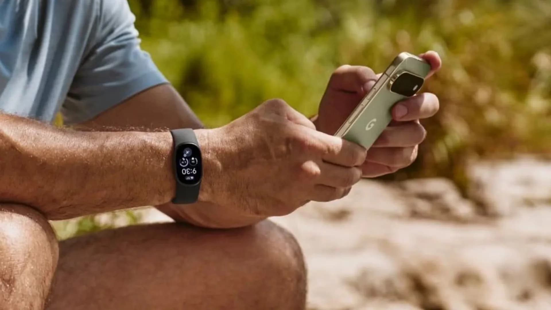 Fitbit Edge wearable on wrist, showing bright AMOLED display with activity stats