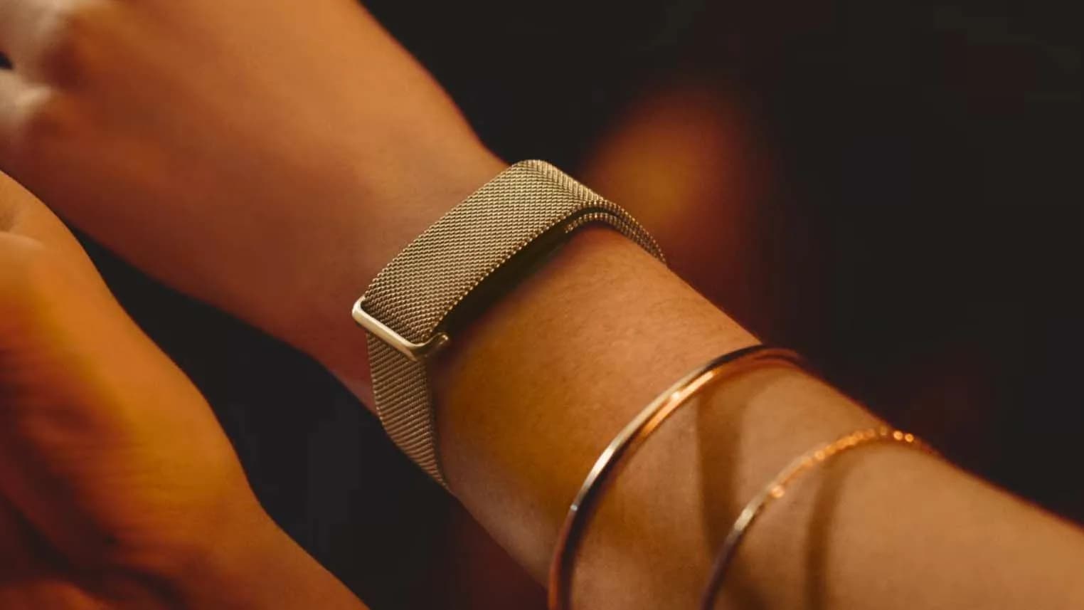 Fitbit Air with new stainless steel mesh band in champagne gold, worn on wrist