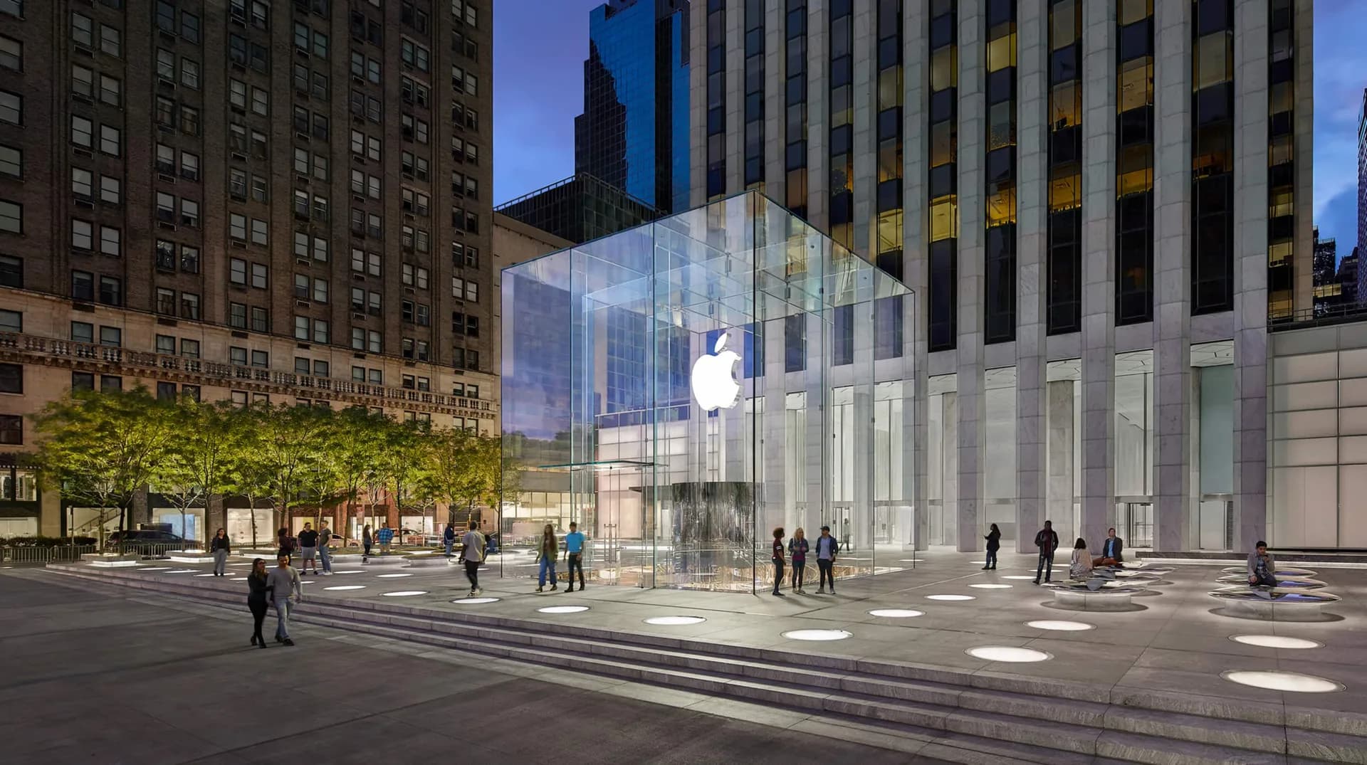 Apple's white display table with central post, set up for iPhone Duo demos