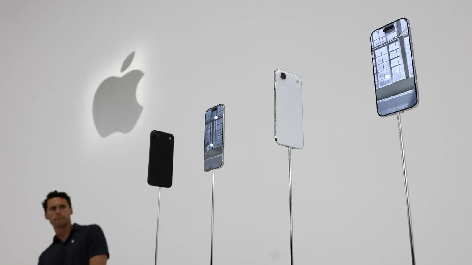 Side-by-side of iPhone Air and Galaxy S25 Edge on a white surface