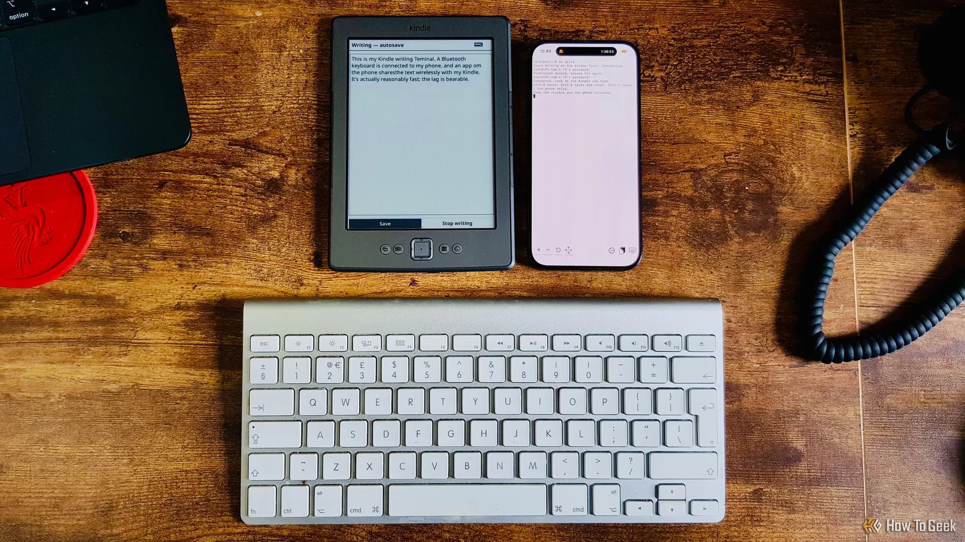 A fourth-generation Kindle with a Bluetooth keyboard beside it, screen showing plain text in KOReader