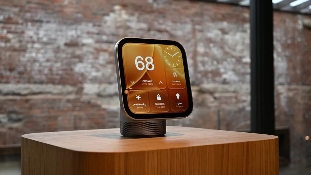 Apple HomeView mounted on a white wall beside a bed, showing the Snoopy face with umbrella icon visible — weather overlay active.