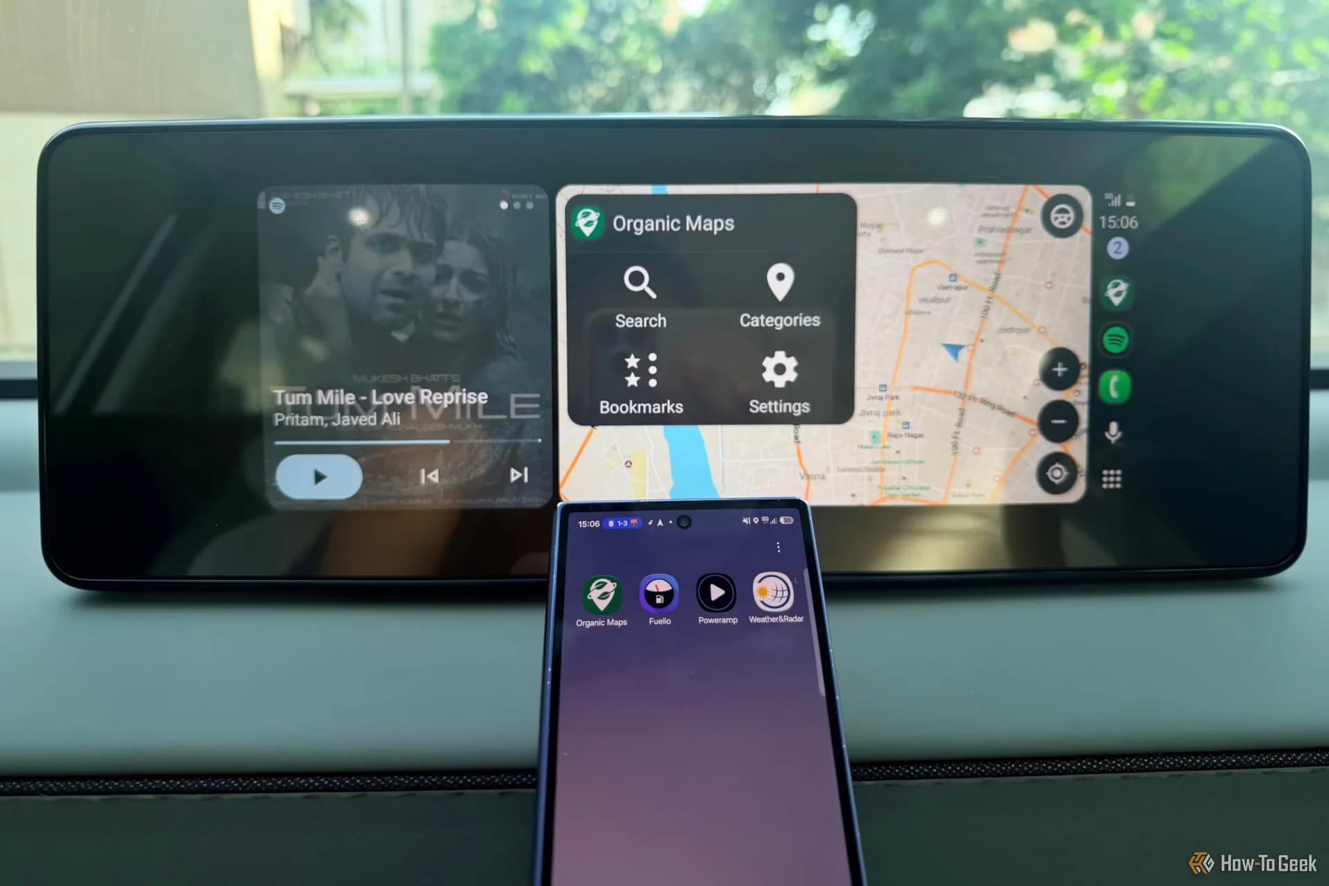 An in-car dashboard display showing an Android Auto interface with navigation and media controls.