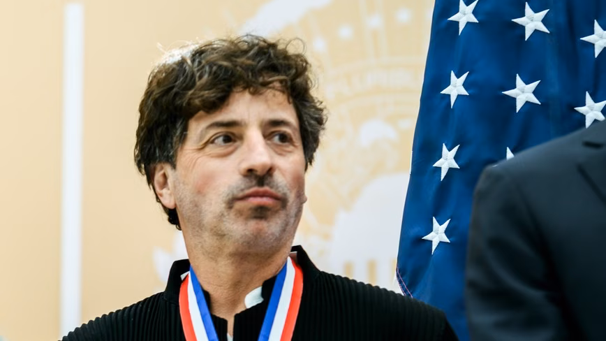 Sergey Brin speaking at a podium in Washington, D.C., on 8 October 2026