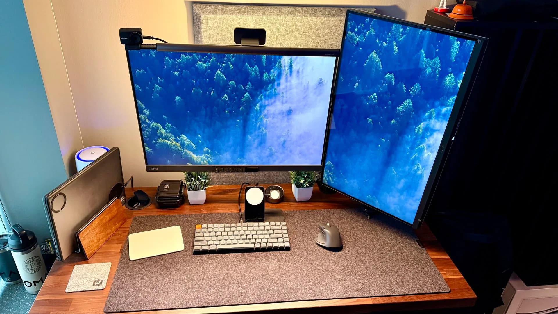 A curated home office setup with a standing desk, ergonomic chair, webcam, and mechanical keyboard