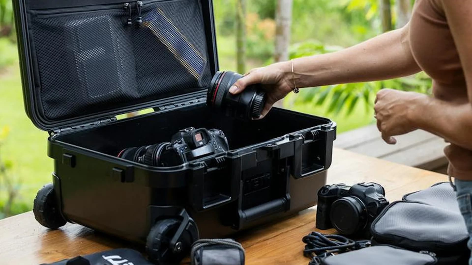 Yeti LoadOut GoBox 28 hard-shell roller case in tan, open with camera gear inside and Kor insert visible
