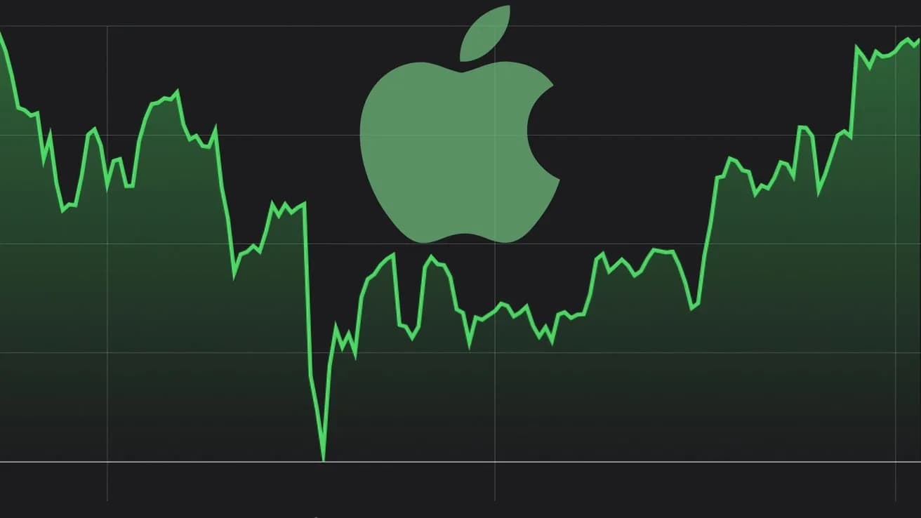 Apple logo mounted on a glass storefront with display tables inside.