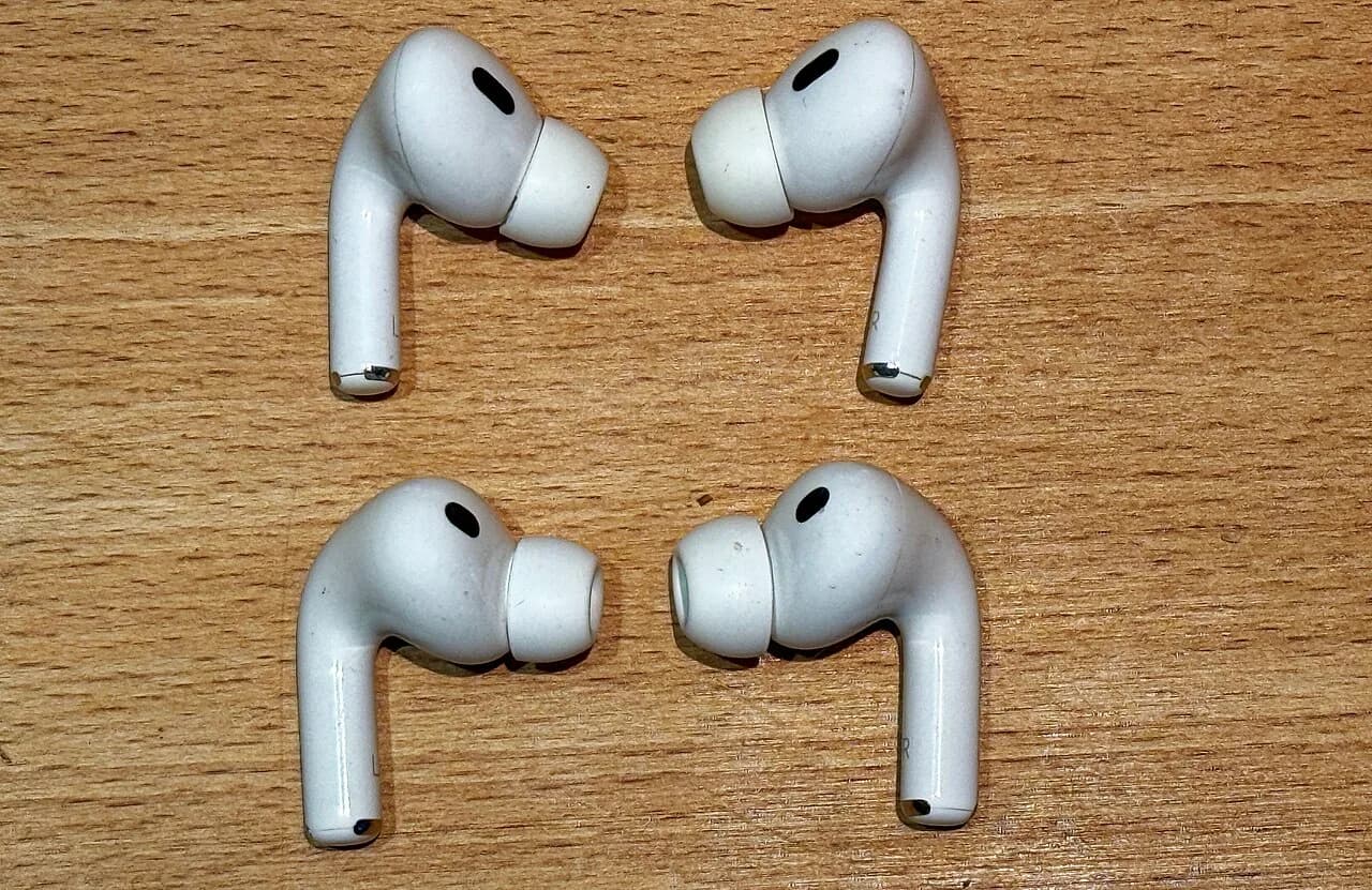 Two generations of Apple AirPods Pro earbuds side by side