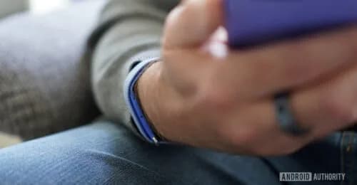 A Fitbit Air fitness tracker worn on a wrist showing a sleep tracking screen