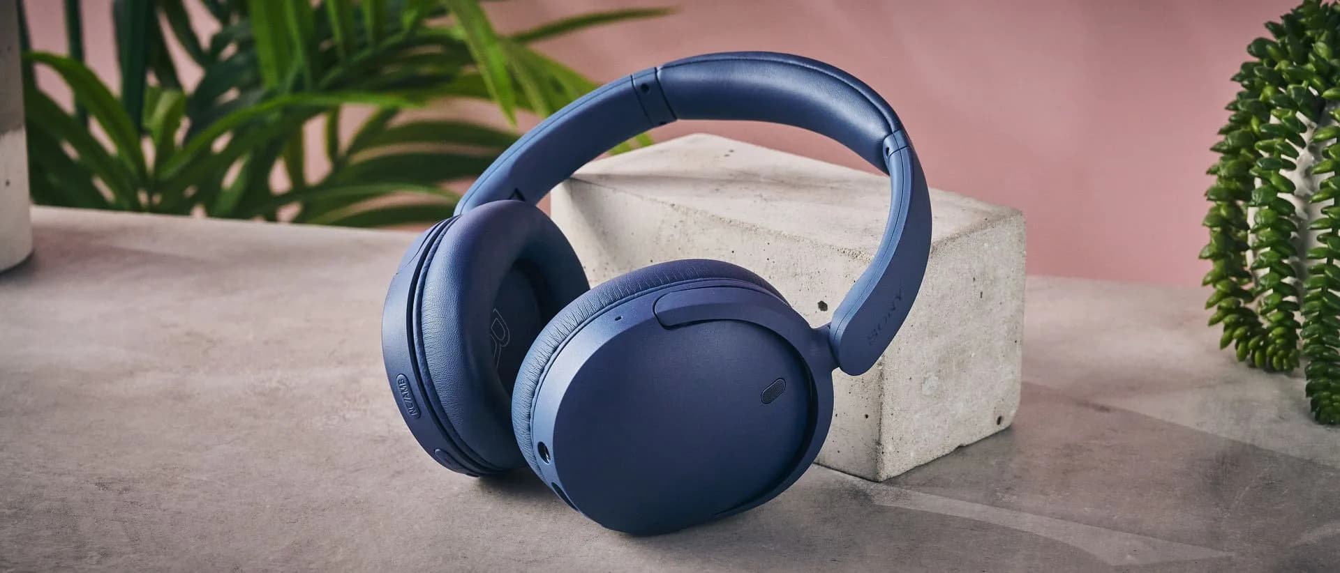 Sony WH-CH730N wireless headphones folded flat on a white surface